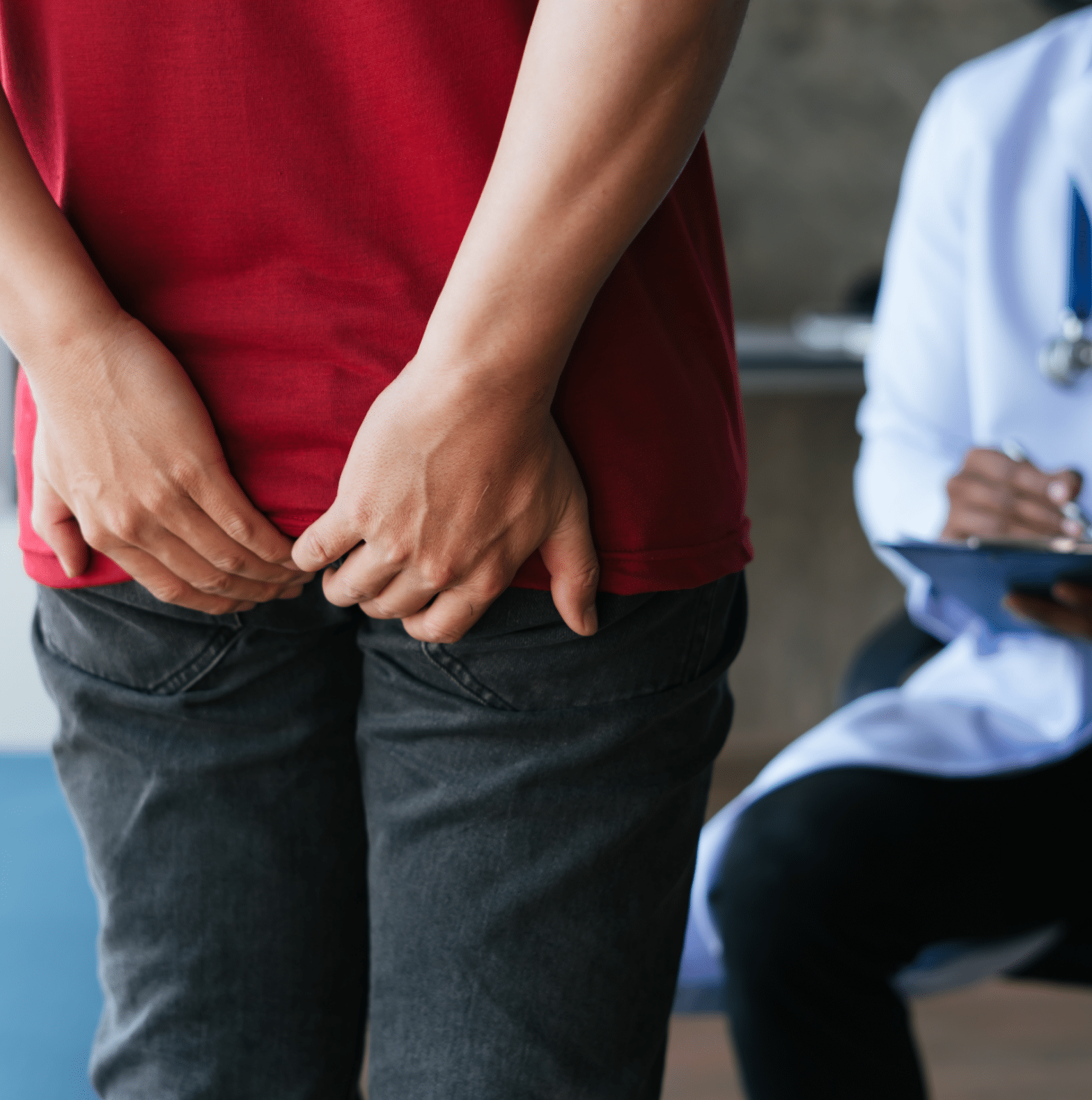 Man seeing a doctor with hands on buttocks